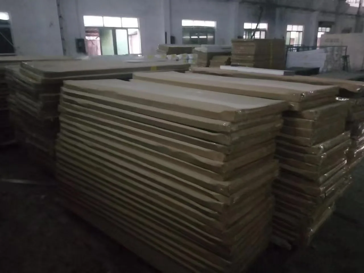 Door panels stacked inside a workshop